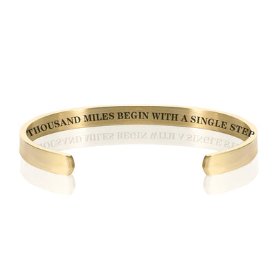 THOUSAND MILES BEGIN WITH A SINGLE STEP BRACELET BANGLE - Gold